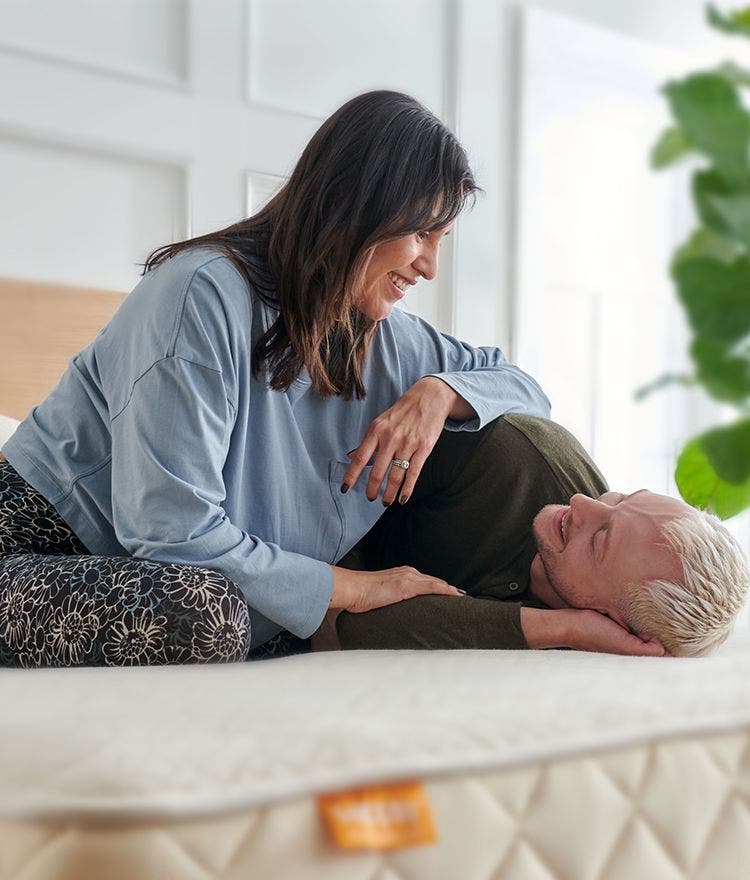 couple cuddling on happsy organic mattress
