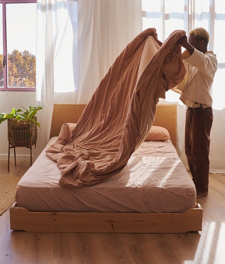 person making the bed