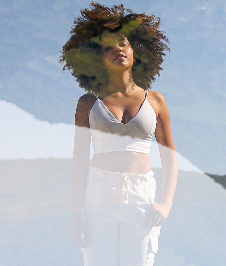 image of woman double exposed with nature background to portray a dream-like state