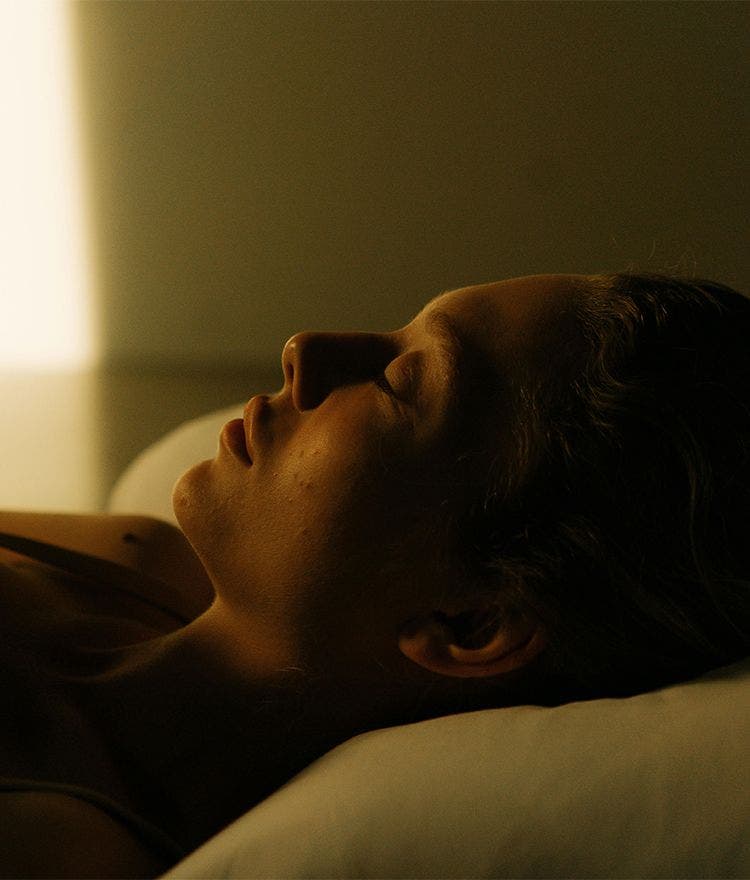 person sleeping in a room with early morning sunlight