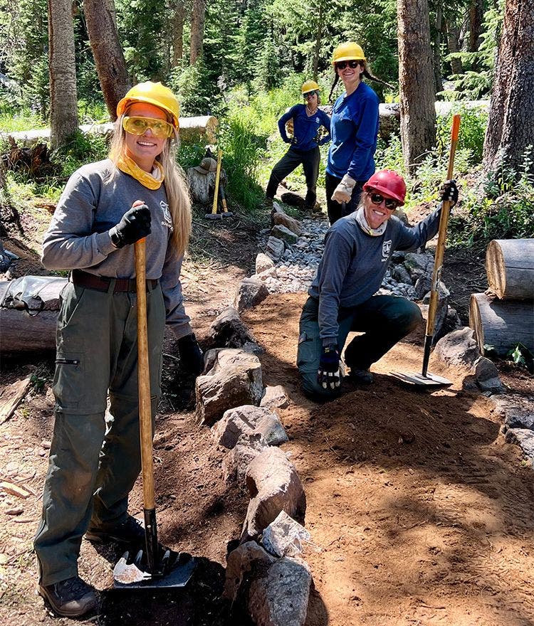 women volunteering in the outdoors with wilderness volunteers