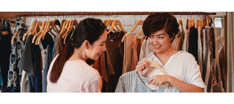 Two woman shopping for organic clothing on Black Friday