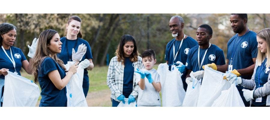 Group of volunteers cleaning up a park as a way to give back