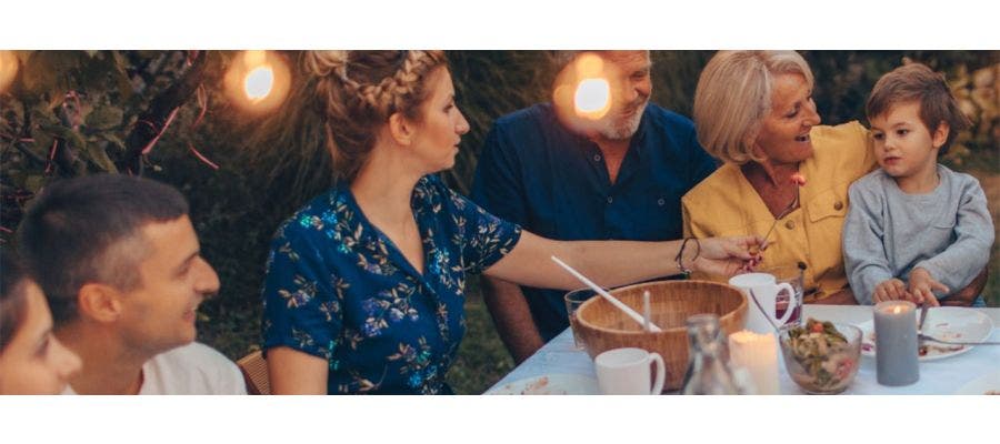 Family enjoying a sustainable Thanksgiving dinner outdoors