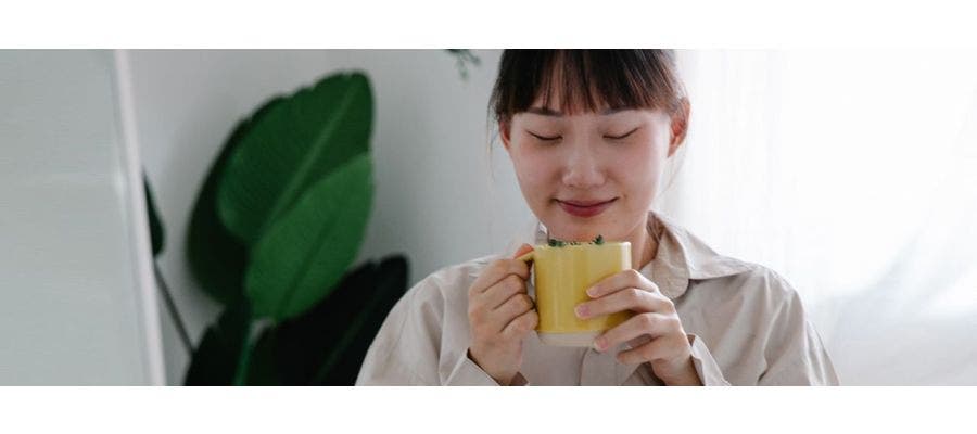 Well rested woman sipping a calming tea