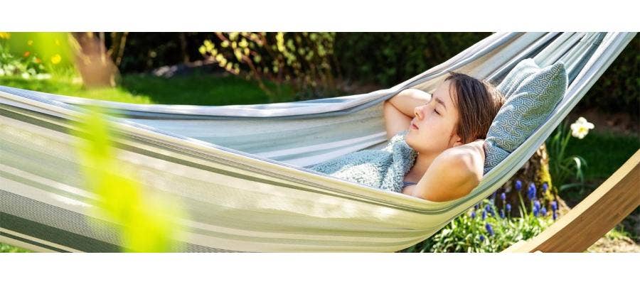 Young woman sleeping on a hammock in the sunshine