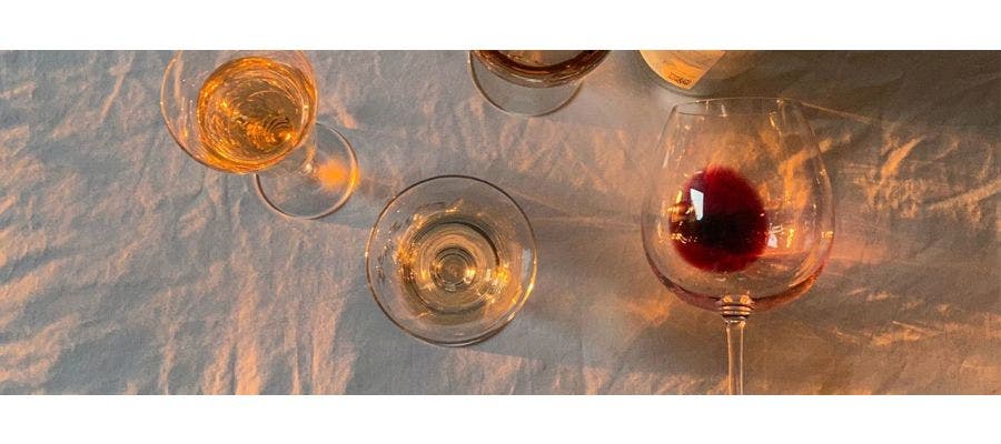 Wine bottle and partly filled wine glasses on a table