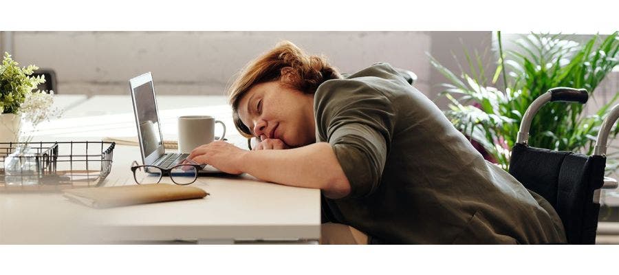 Woman falling asleep at her work desk