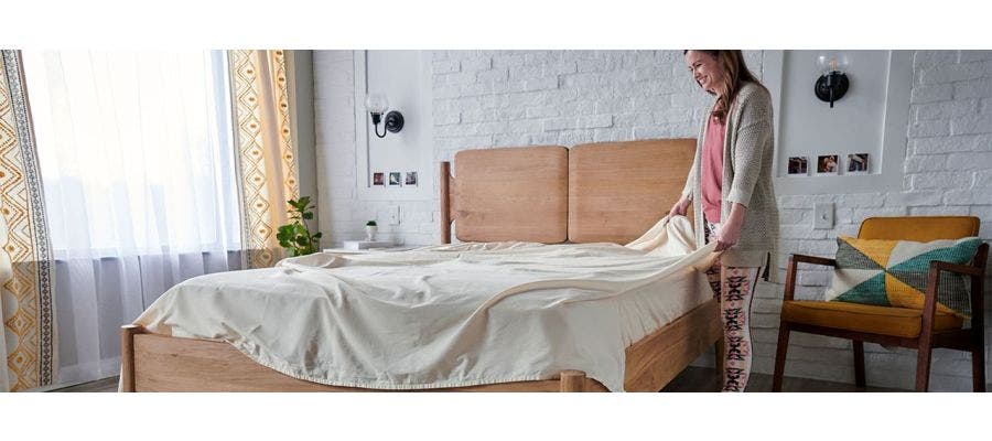 Woman making the bed in the morning