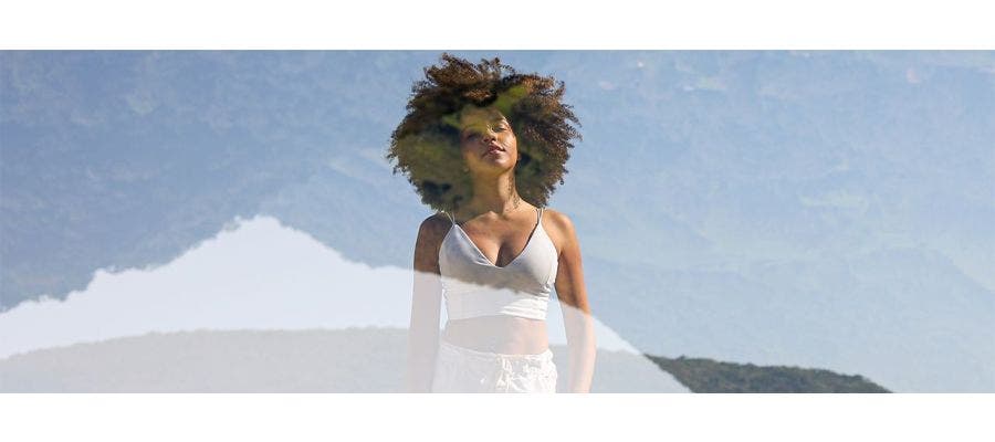image of woman double exposed with nature background to portray a dream-like state