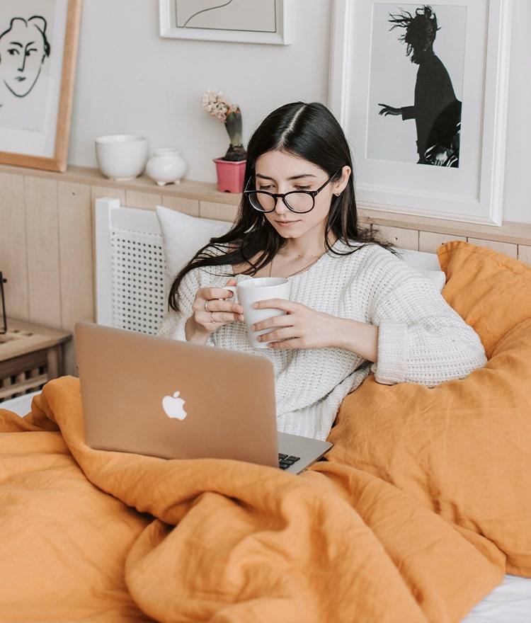 Well rested woman relaxing in bed after the fall time change