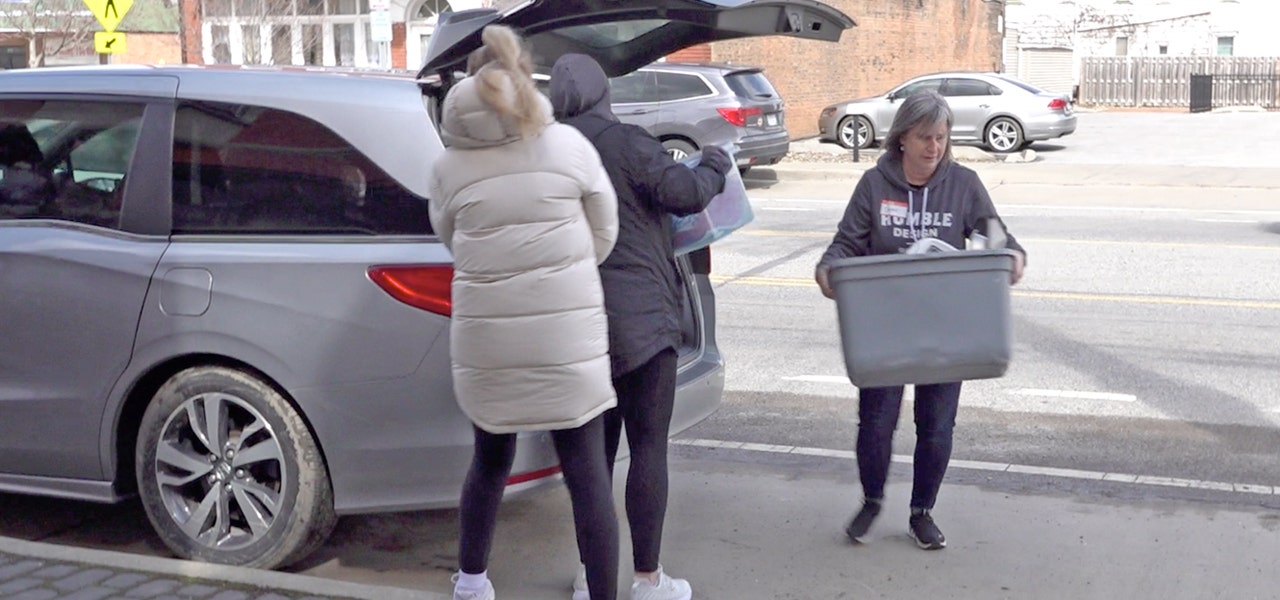 Happsy volunteers unloading mattress donations for Humble Design