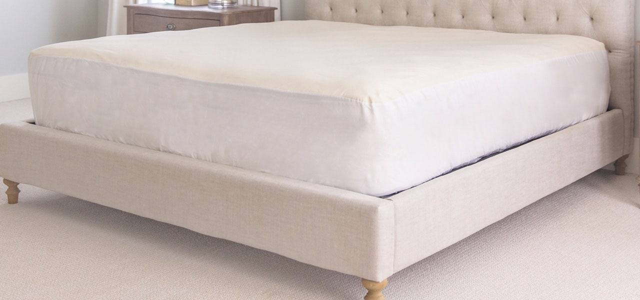 Clean, fresh bedroom with a Happsy organic mattress and mattress protector 