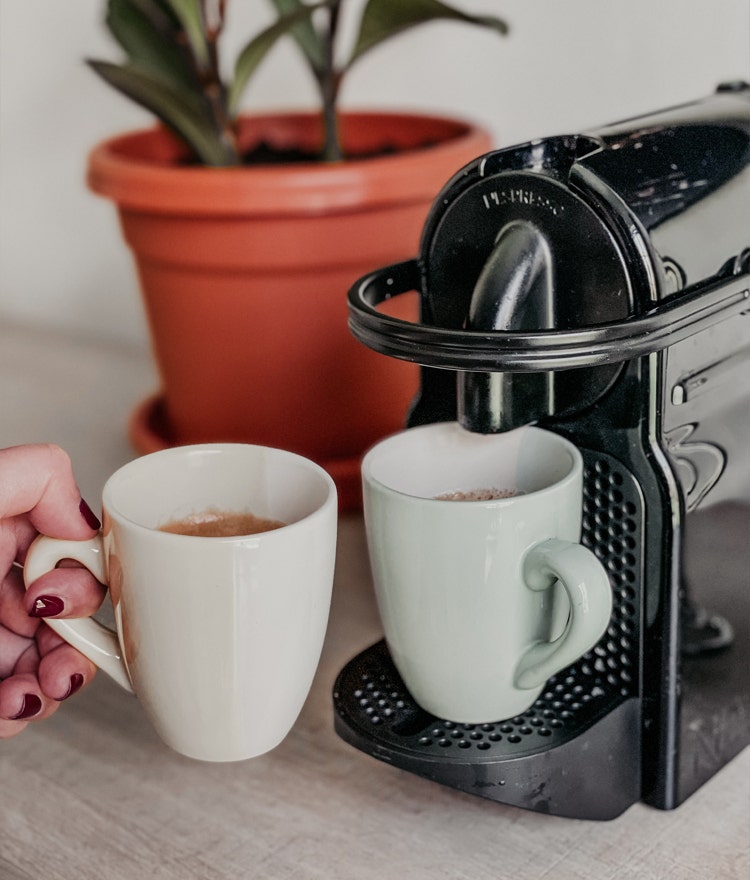 Woman getting a hot vup of fresh coffee