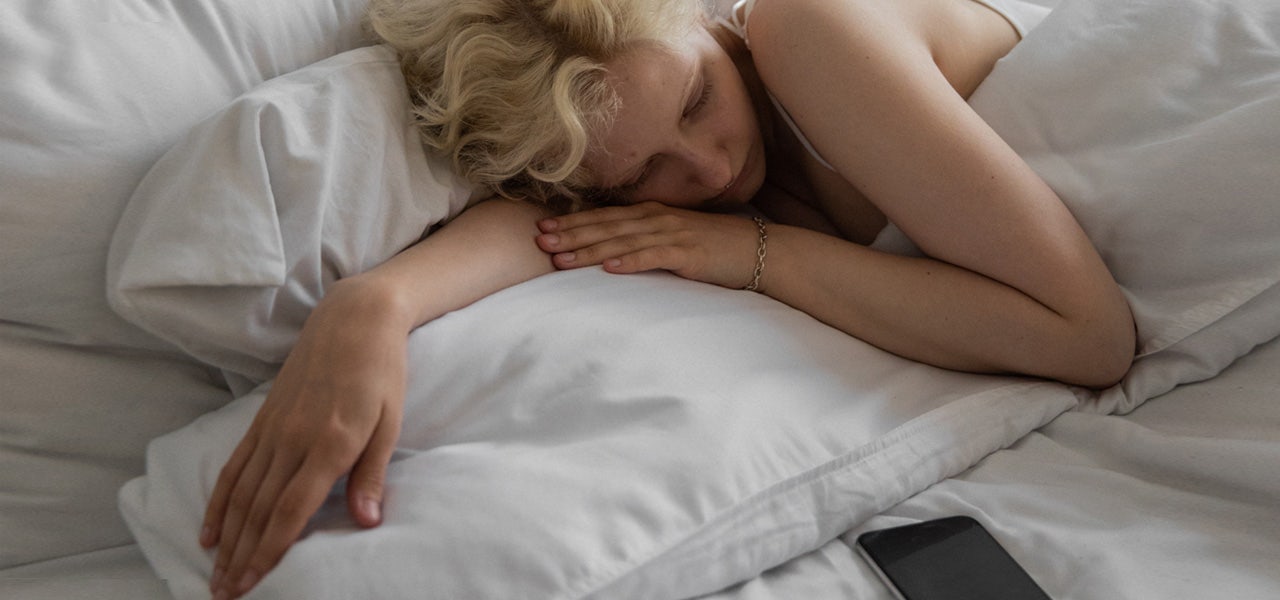 Young woman sleeping soundly in her bed