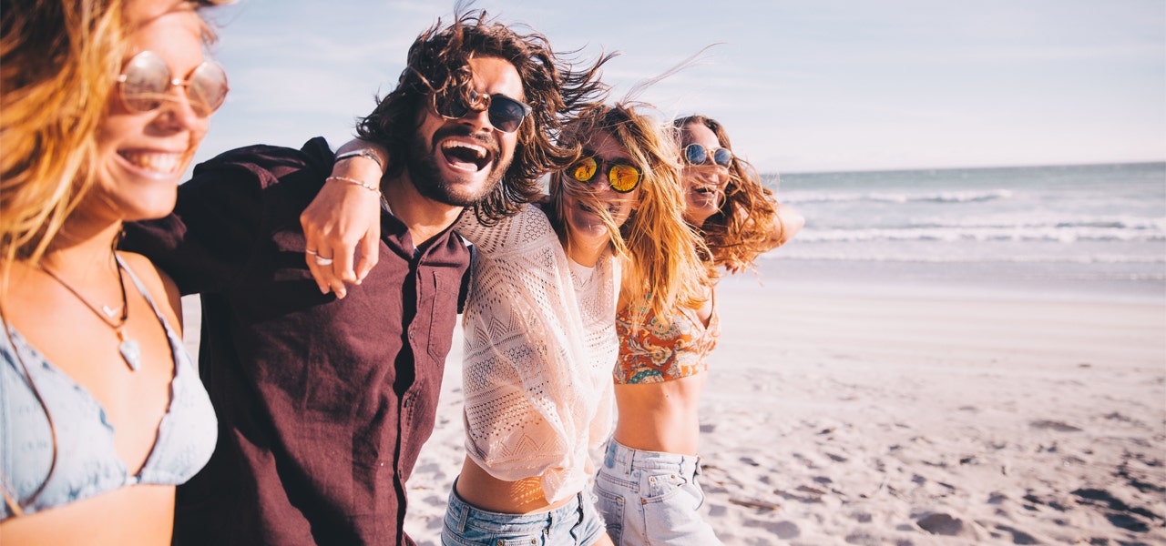 Group of friends hanging out on the beach