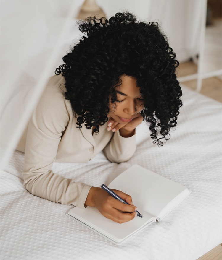 Woman journaling as part of her bedtime routine