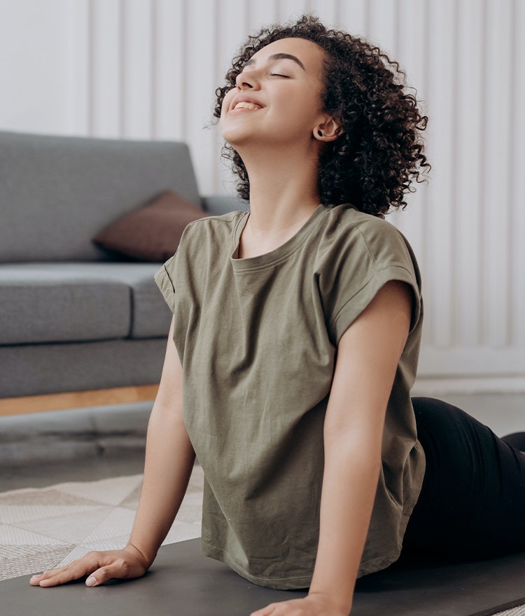 Young woman smiling and practing yoga