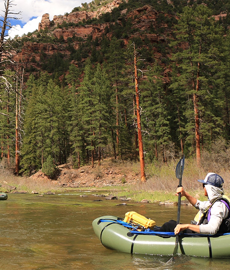 A person kayaking on a beautiful river