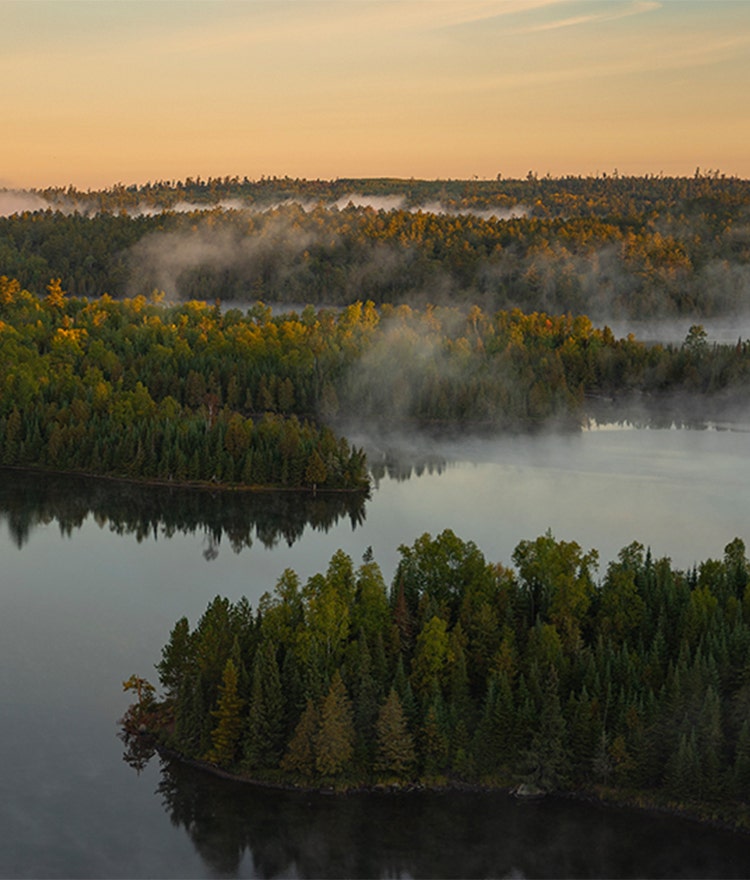 Mist rising off of a lake during sunrise