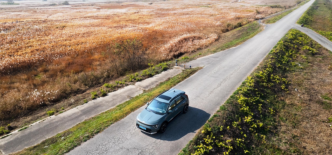 Single car driving on an empty, remote road 