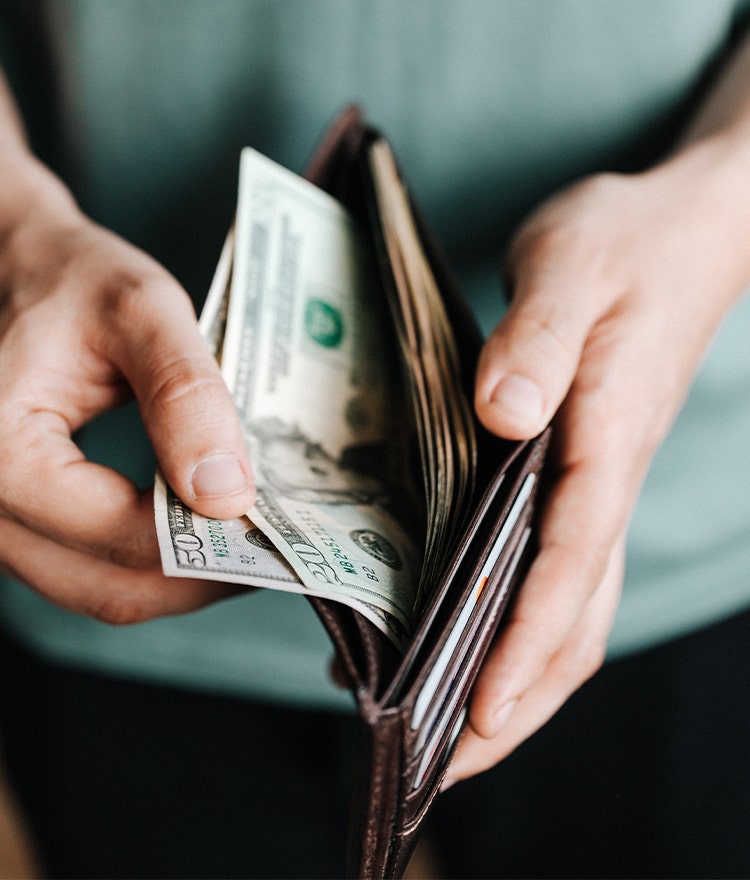 Man counting out bills from his wallet