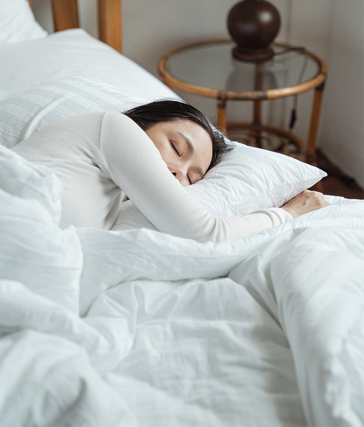 Woman soundly sleeping in her bed