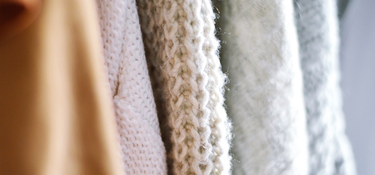 A variety of fabrics hanging on a rack