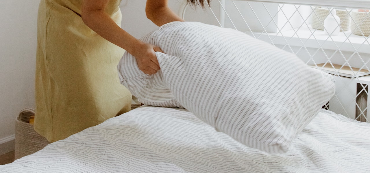 Woman making her bed in the morning