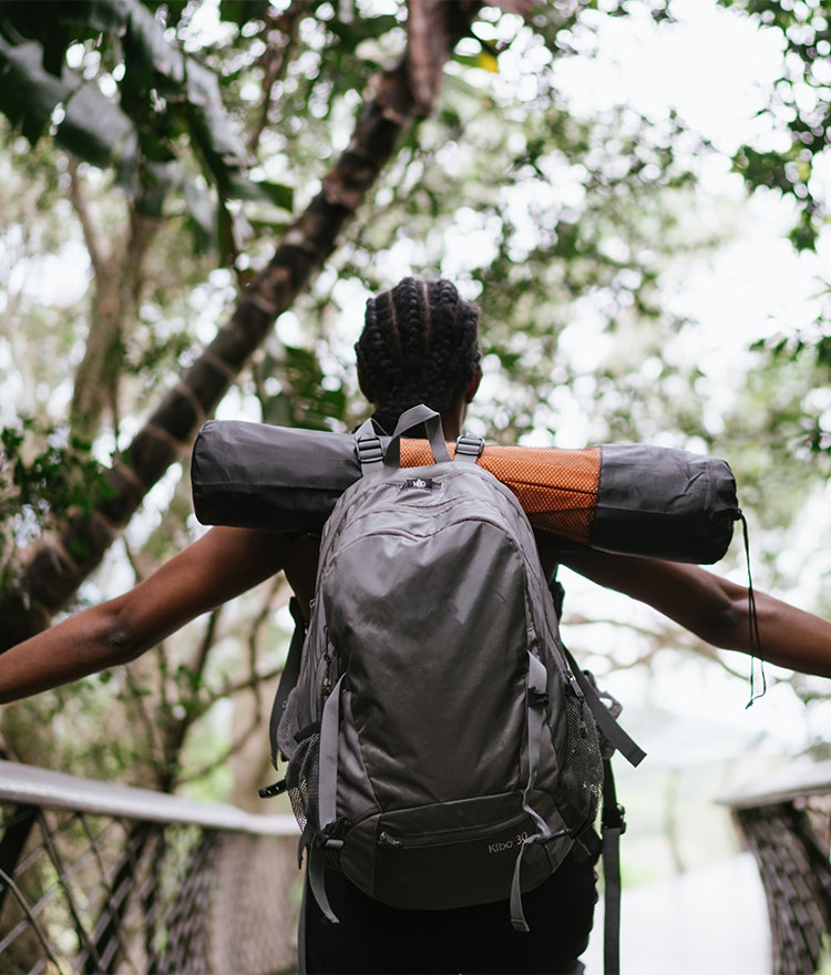 Person hiking in the woods as spiritual self-care