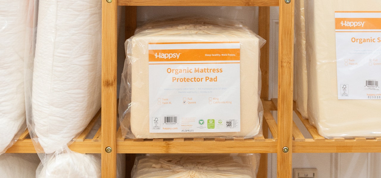 happsy organic mattress protector pad in a package on a shelf